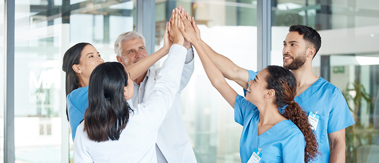 Shot of a team of medical staff high fiving one another Providing motivation in these trying times